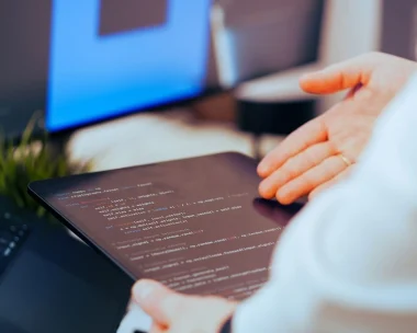 Modern mobile app development interface showing UI/UX design screens and coding environment representing app development companies in Lebanon by Sync